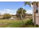 Waterfront backyard features mature palms and lush greenery, enhancing the property's appeal at 2480 Royal Oak Dr, Johns Island, SC 29455