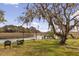 Scenic waterfront backyard with lush greenery and a charming seating area with lake views at 2480 Royal Oak Dr, Johns Island, SC 29455