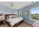 Bright bedroom with a queen bed, bedside tables with lamps, an exterior view, and a ceiling fan at 2480 Royal Oak Dr, Johns Island, SC 29455