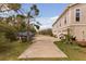 Driveway view leading to the house, including a boat, three-car garage and nice landscaping at 2480 Royal Oak Dr, Johns Island, SC 29455