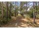 Gravel path winding through tall trees, offering a secluded and picturesque entrance to the property at 2480 Royal Oak Dr, Johns Island, SC 29455