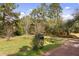 View of the driveway, surrounded by trees, showing the approach to the property and its natural setting at 2480 Royal Oak Dr, Johns Island, SC 29455