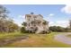Charming two-story home with a wooden staircase and beautiful palm trees adorning the front yard at 2480 Royal Oak Dr, Johns Island, SC 29455