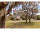 Charming exterior view of the home through trees with Spanish moss at 2480 Royal Oak Dr, Johns Island, SC 29455
