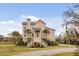 Charming two-story coastal home with landscaped yard, inviting staircase, and covered entry at 2480 Royal Oak Dr, Johns Island, SC 29455