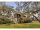 Backyard view of the home from yard with stairs to porch near lake at 2480 Royal Oak Dr, Johns Island, SC 29455