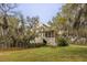Backyard view of the home from yard with stairs to porch near lake at 2480 Royal Oak Dr, Johns Island, SC 29455