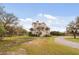 Charming coastal home featuring a two-story design and mature landscaping surrounded by mature trees at 2480 Royal Oak Dr, Johns Island, SC 29455