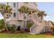 A beautiful exterior view of the home with palm trees at 2480 Royal Oak Dr, Johns Island, SC 29455