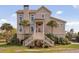 A beautiful exterior view of the home with palm trees at 2480 Royal Oak Dr, Johns Island, SC 29455