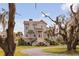 Exterior shot of the home showcasing the front yard, entrance steps, and mature landscaping at 2480 Royal Oak Dr, Johns Island, SC 29455