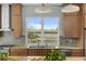 Modern kitchen features wood cabinets, tile backsplash, and a large window with a backyard view at 2480 Royal Oak Dr, Johns Island, SC 29455