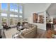Spacious living room featuring hardwood floors, high ceilings, and an abundance of natural light at 2480 Royal Oak Dr, Johns Island, SC 29455