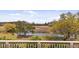 Enjoy waterfront views from the home's porch, featuring lush landscaping and mature trees at 2480 Royal Oak Dr, Johns Island, SC 29455