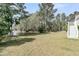 Lush green backyard leading to a serene pond, surrounded by tall trees offering privacy at 2504 Ballast Pt, Mount Pleasant, SC 29466