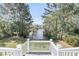Scenic backyard view from an elevated porch, featuring a tranquil pond surrounded by trees at 2504 Ballast Pt, Mount Pleasant, SC 29466