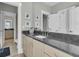 Bathroom with granite countertop, sink, framed art, and a door leading to an adjacent bathroom at 2504 Ballast Pt, Mount Pleasant, SC 29466