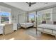 Sunlit bedroom features two beds, a ceiling fan, neutral walls, and large windows for a bright and airy atmosphere at 2504 Ballast Pt, Mount Pleasant, SC 29466