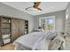 This bedroom features a ceiling fan, a shelving unit and a desk with French doors leading to a balcony at 2504 Ballast Pt, Mount Pleasant, SC 29466