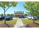 Picturesque view of the clubhouse framed by lush trees, set amidst manicured lawns and ample parking at 2504 Ballast Pt, Mount Pleasant, SC 29466