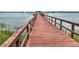 Long wooden dock extends into the calm water, providing a peaceful spot for fishing and enjoying the waterfront view at 2504 Ballast Pt, Mount Pleasant, SC 29466