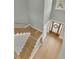A foyer with hardwood floors, staircase, and a wood door with a wreath, giving off a warm welcoming vibe at 2504 Ballast Pt, Mount Pleasant, SC 29466