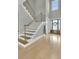 Grand foyer showcasing a staircase with metal railings, wood floors, and a front door with sidelights at 2504 Ballast Pt, Mount Pleasant, SC 29466