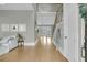 Bright foyer with wood floors, a staircase, and a view into the living room through French doors at 2504 Ballast Pt, Mount Pleasant, SC 29466