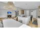 Spacious kitchen featuring a large island with seating, a modern light fixture, and a view of the staircase at 2504 Ballast Pt, Mount Pleasant, SC 29466