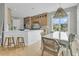 Kitchen and dining area with wood cabinets, marble countertops, and stylish pendant lighting at 2504 Ballast Pt, Mount Pleasant, SC 29466
