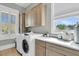 Bright laundry room with modern washer, dryer, and marble folding countertops at 2504 Ballast Pt, Mount Pleasant, SC 29466