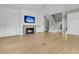 Spacious living room with fireplace, built-in shelves, and an elegant staircase at 2504 Ballast Pt, Mount Pleasant, SC 29466