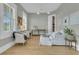 Cozy living room featuring white sofas, shuttered windows, and a view into the dining area at 2504 Ballast Pt, Mount Pleasant, SC 29466