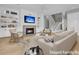 Comfortable staged living room with a fireplace, built-in shelves, and a view of the staircase at 2504 Ballast Pt, Mount Pleasant, SC 29466
