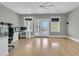 Spacious room with hardwood floors, natural light, and double doors leading to a balcony with water views at 2504 Ballast Pt, Mount Pleasant, SC 29466