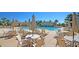 Resort-style pool area with lounge chairs, umbrellas, and tables for relaxing and enjoying the outdoors at 2504 Ballast Pt, Mount Pleasant, SC 29466