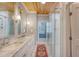 Bright bathroom with a glass shower, double sinks, and wallpaper at 304 Bank St, Mount Pleasant, SC 29464