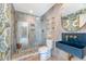 Unique bathroom with a blue sink, floral wallpaper, and glass enclosed shower at 304 Bank St, Mount Pleasant, SC 29464