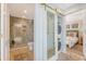 Bathroom and shower with tan tile and gold fixtures and a view of the laundry and bedroom at 304 Bank St, Mount Pleasant, SC 29464