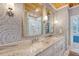Well decorated bathroom with double vanity, granite counter tops, and tiled shower at 304 Bank St, Mount Pleasant, SC 29464