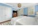Bedroom with a bed, hardwood floors, bright blue walls, and shuttered windows at 304 Bank St, Mount Pleasant, SC 29464