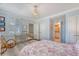 Light filled bedroom with decoratively framed shutters, a desk, and wicker chair at 304 Bank St, Mount Pleasant, SC 29464
