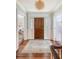 Inviting entryway with hardwood floors, wooden door, and decorative area rug at 304 Bank St, Mount Pleasant, SC 29464