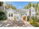 Charming home with white siding, a brick path, lush landscaping, and a wooden gate at 304 Bank St, Mount Pleasant, SC 29464