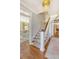 Open foyer with staircase featuring hardwood floors and decorative chandelier lighting at 304 Bank St, Mount Pleasant, SC 29464