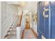 Inviting foyer with elegant staircase, chandelier, and hardwood floors at 304 Bank St, Mount Pleasant, SC 29464