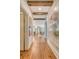 Hallway featuring hardwood floors and striking wall art leading into the living room at 304 Bank St, Mount Pleasant, SC 29464
