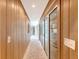 Hallway with light wood paneling and tile flooring leading to another room with glass doors at 304 Bank St, Mount Pleasant, SC 29464