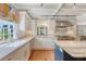 Bright kitchen with white cabinets, marble countertops and backsplash, and stainless steel appliances at 304 Bank St, Mount Pleasant, SC 29464