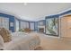 Large main bedroom boasts carpet, fireplace, piano, seating, windows, and an ensuite bathroom at 304 Bank St, Mount Pleasant, SC 29464